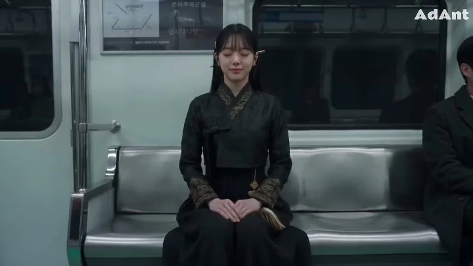 Opening frame of a cinematic horror reel: a woman sitting calmly in an empty subway car
